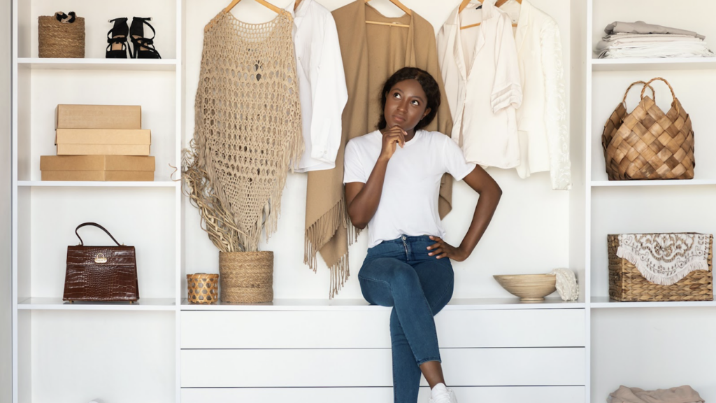Women in a closet full of a Capsule Wardrobe
